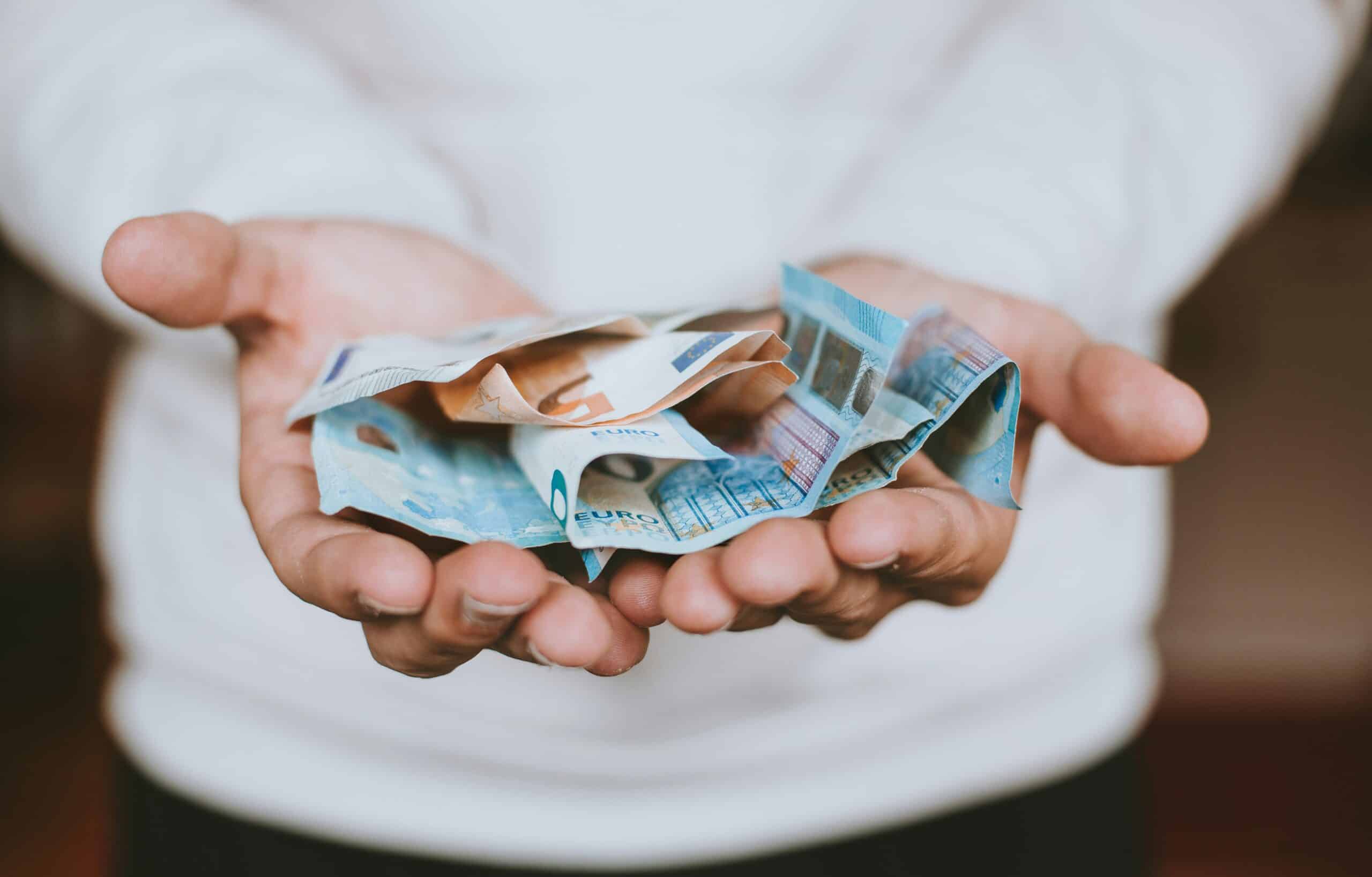 A person holding Euros