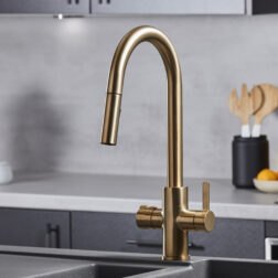 a swan neck pull-out hot water tap in brushed gold