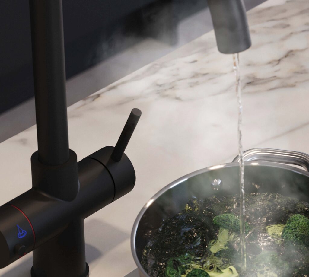 a close up image of a boiling water tap blanching a bowl of Broccoli.